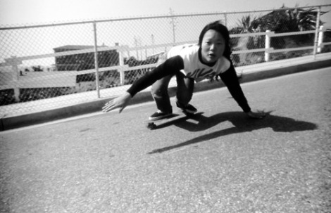 [peggy oki demonstrating a burt move, dragging her hand on asphalt as if she were surfing]